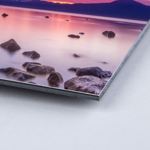 Shot of corner of photograph mounted to board with image of the ocean